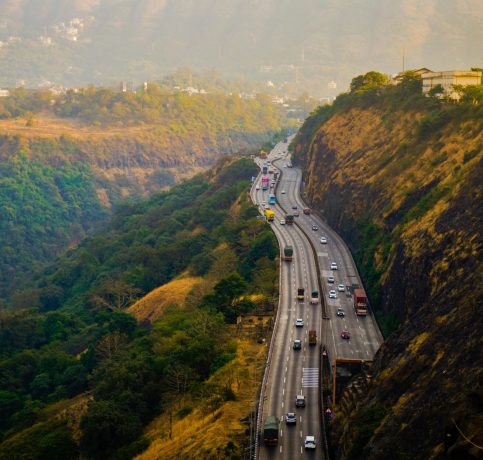 A scenic view of a busy highway winding through the lush hills of Lonavala, Maharashtra, India.